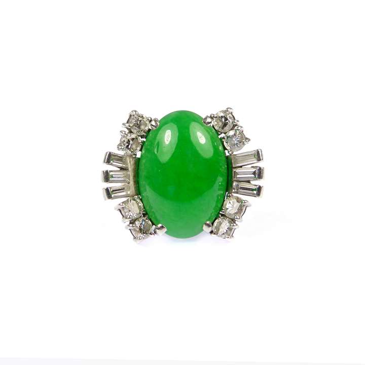 Single stone jade and diamond cluster ring, the oval jade between baguette diamond fans,